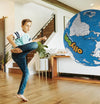 Child kicking large Planet Ollylball indoors