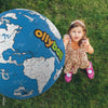 Child playing with a large Planet Ollyball outdoors